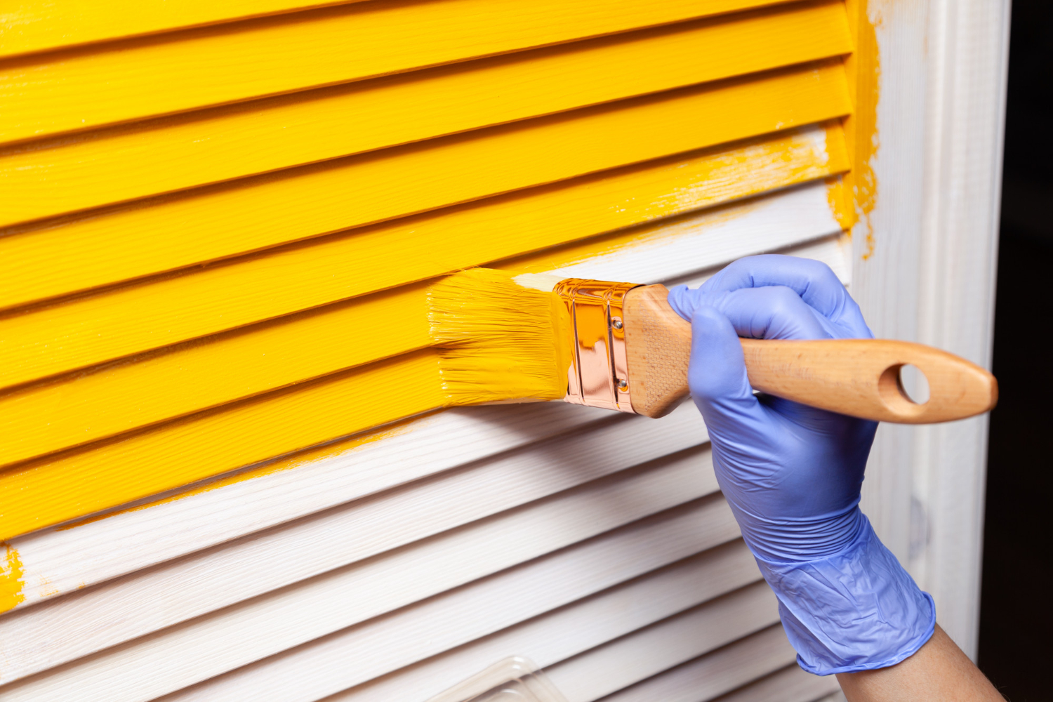 Profissional prepara área para pintura de portão de garagem